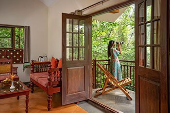 Living room and balcony view at Vythiri Mist Resort