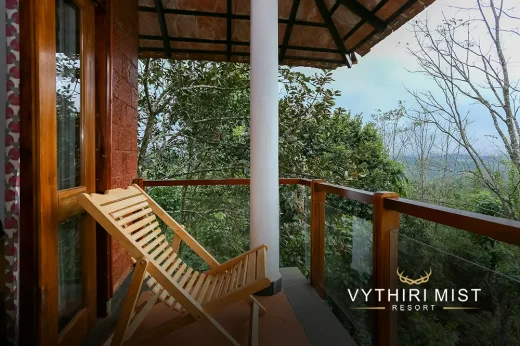 Private balcony with stunning views and outdoor seating area at Vythiri Mist Resort