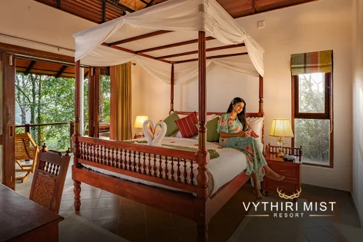 Cozy bedroom with comfortable seating and modern amenities at Vythiri Mist Resort