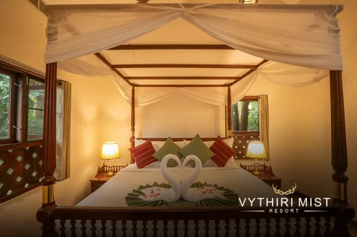 Luxurious bedroom with plush bedding and scenic views at Vythiri Mist Resort